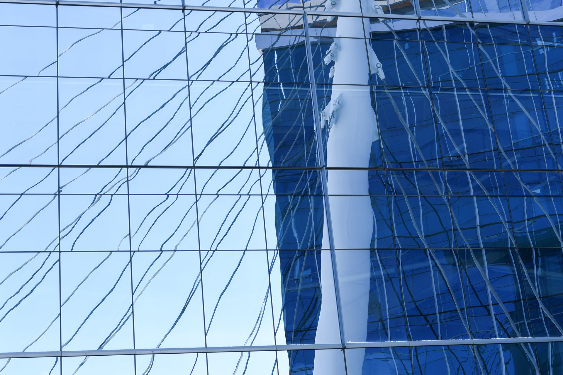 Modern building facade reflected in glass