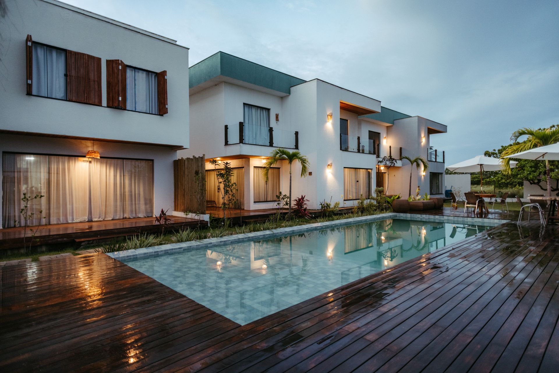Modern villa at twilight with poolside view